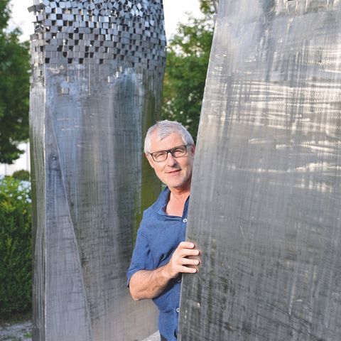 Künstler bei seiner Skulptur Künstler bei seiner Skulptur in Irsee im Ostallgäu.